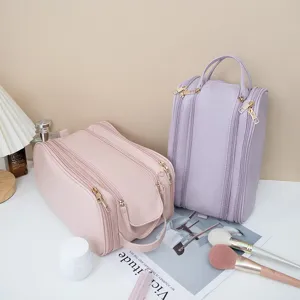 Detailed view of large capacity travel cosmetic bag, multi-layer zipper design for makeup storage.