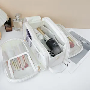 Detail shot of white travel makeup bag with multi-compartments and brush slots for daily use.