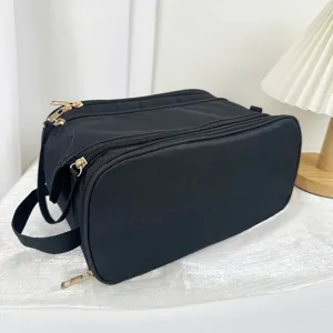 Black multi-functional cosmetic bag detail, large capacity toiletry storage pouch with gold zippers.