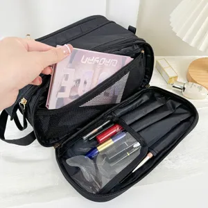 Detailed view of the multi-functional black cosmetic bag interior with compartments and mesh pockets.