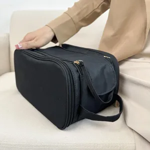 Large capacity black multi-functional cosmetic bag detail shot for convenient travel storage.