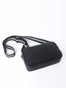 Detailed view of black PU leather crossbody bag, featuring a striped strap and metal hardware.