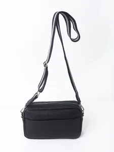 Detailed shot of black PU leather crossbody bag with adjustable wide striped shoulder strap.