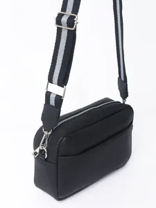 Black PU leather crossbody bag detail, wide striped strap and silver hardware accents.