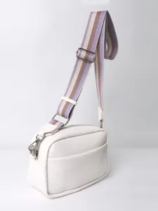 White PU leather crossbody bag detail, featuring adjustable striped strap and metal zippers.