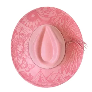 Pink suede western cowboy hat with laser engraved tribal patterns and side fringe.