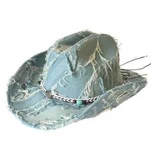 Close-up of distressed denim cowboy hat wide brim frayed fringe boho fashion detail shot