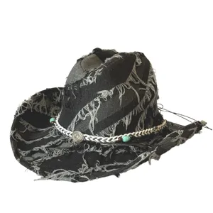 Close-up view of vintage distressed denim cowboy hat showing frayed edges and beaded hatband.