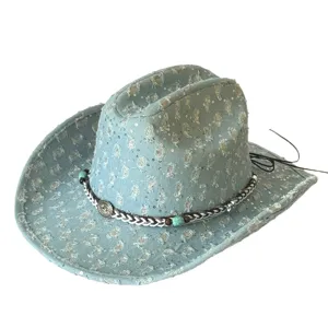 Detail view of distressed denim western cowboy hat with sequins and beaded band.
