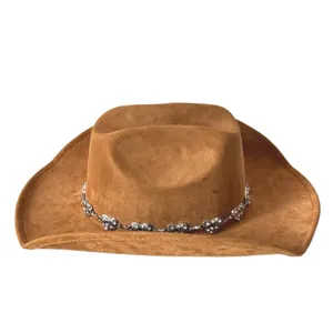 Vintage brown suede western cowboy hat with rhinestone silver metal chain detail outdoor