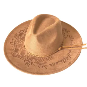 Brown suede fedora hat featuring laser-engraved daisy floral pattern and western style.