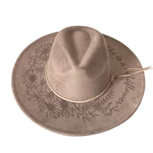 Laser-engraved floral fedora hat detail, suede texture with braided tassel hatband.