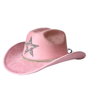 Pink faux suede western cowboy hat with rhinestone star and sparkling crystal band for party style.
