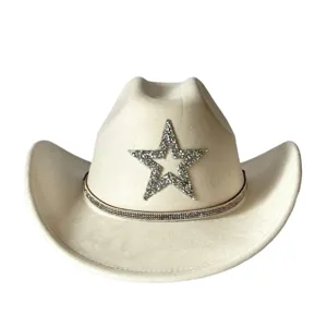 Close up showing rhinestone star and sparkling band on beige suede western cowboy hat detail