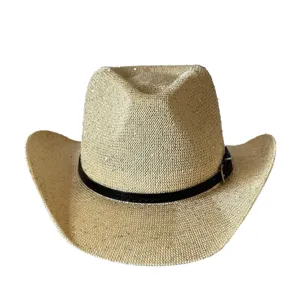 Primo piano sui dettagli del cappello da cowboy con paillettes e cinturino con fibbia nera.
