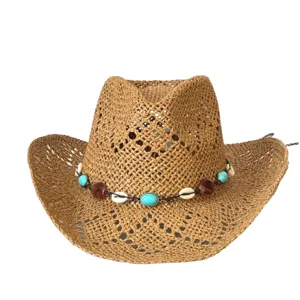 Bohemian straw hat detail showing woven texture and shell turquoise beaded band summer beach sun.