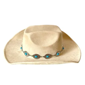 Detailed shot of retro beige suede western cowboy hat featuring decorative turquoise metal band.