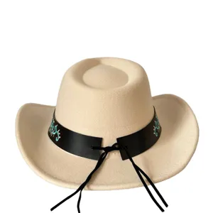 Gros plan détail du chapeau de cowboy en laine beige avec bande en cuir noir et broderie turquoise.