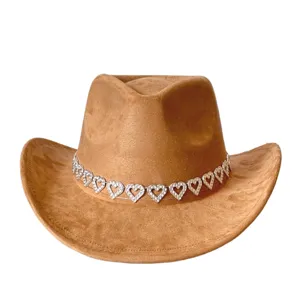 Detailed view of the brown suede cowboy hat featuring a sparkling rhinestone heart chain band.