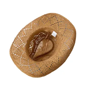 Detailed view of the hollow-out straw cowboy hat inner structure, comfortable sweatband design.