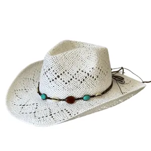 Close-up of a white woven straw cowboy hat featuring a bohemian turquoise and shell beaded band.