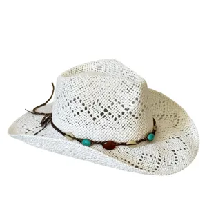 Detail shot of bohemian hollow-out straw cowboy hat with beaded band for summer beach vacation.
