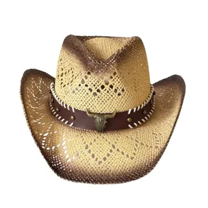 Detailed view of western straw cowboy hat with hollow weave and bull skull emblem.