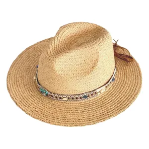 Close-up of a stylish straw hat featuring an intricate beaded band and chic leather fringe detail.