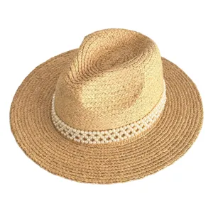Detailed close-up of a stylish straw sun hat featuring an elegant faux pearl band decoration.
