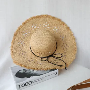 French style hollow raffia straw hat detail, large brim with frayed edge, beach summer sun hat.