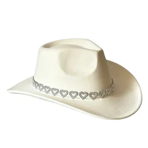 Close-up detail of the vintage off-white suede cowboy hat featuring sparkling rhinestone heart chain.
