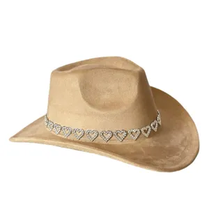 Detailed close-up of the vintage rhinestone heart band on the suede cowboy hat surface.