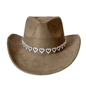 Close up detail of brown faux suede cowboy hat featuring sparkling rhinestone heart chain band
