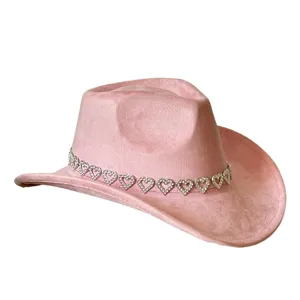 Pink suede western cowboy hat detailed with sparkling rhinestone heart band for party style.