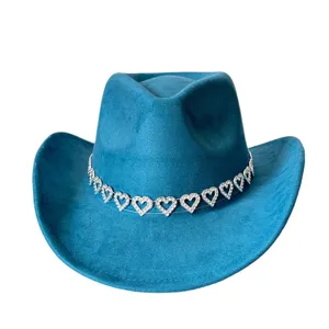 Detailed close-up view of the blue faux suede cowboy hat showing the rhinestone heart chain band.