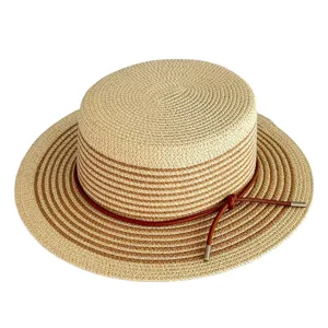 Stylish flat top straw sun hat with contrast brown stripes and leather strap detail for summer beach.