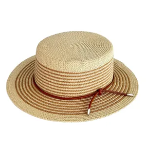 Detail view of the stylish color-blocking straw hat, featuring woven texture and leather rope.