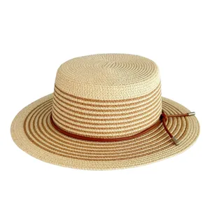 Close-up detail of women's woven straw hat with contrast color stripes and leather cord.