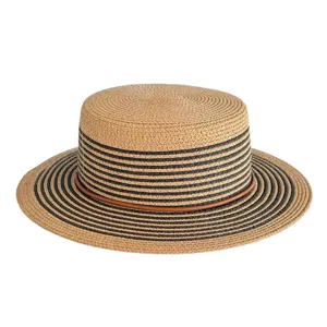Close-up detail of stylish woven straw hat featuring black stripes and brown leather band.