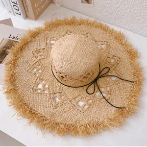 French hollow raffia sun hat with fringe edge and black string, perfect for beach and summer travel.