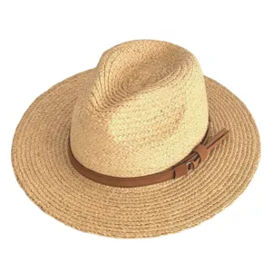 Close-up of the fine raffia straw texture and brown suede hat band detail with metal buckle.