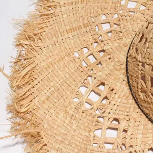 Detailed view of the French hollow-out raffia straw hat with frayed edges for women sun.