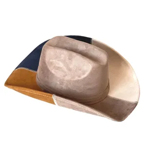Patchwork suede cowboy hat detail, vintage western fedora texture and large brim close-up.