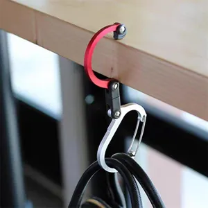Detailed view of portable foldable table bag hook with 360 degree rotation and D-ring.