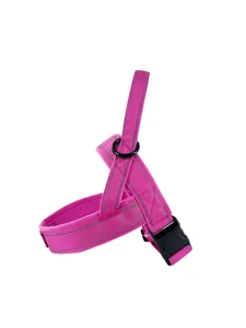 Close-up detail of the pink reflective dog harness, showing durable buckle and D-ring.