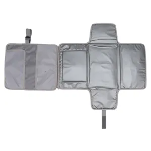 Foldable waterproof baby diaper changing pad detail view, grey portable mat with mesh pockets.