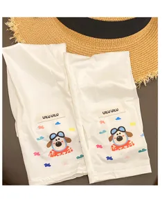 Detail view of white ice silk sun protection sleeves featuring cute cartoon dog and logo tag.