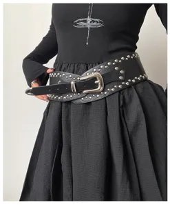Detailed view of women's wide studded leather belt, western style waist corset with metal hardware.