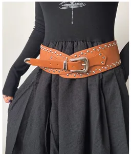 Wide brown studded belt for women, western style leather waist cincher fashion accessory.