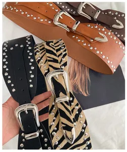 Women's Western style wide studded belt, retro punk metal buckle fashion waist accessory.